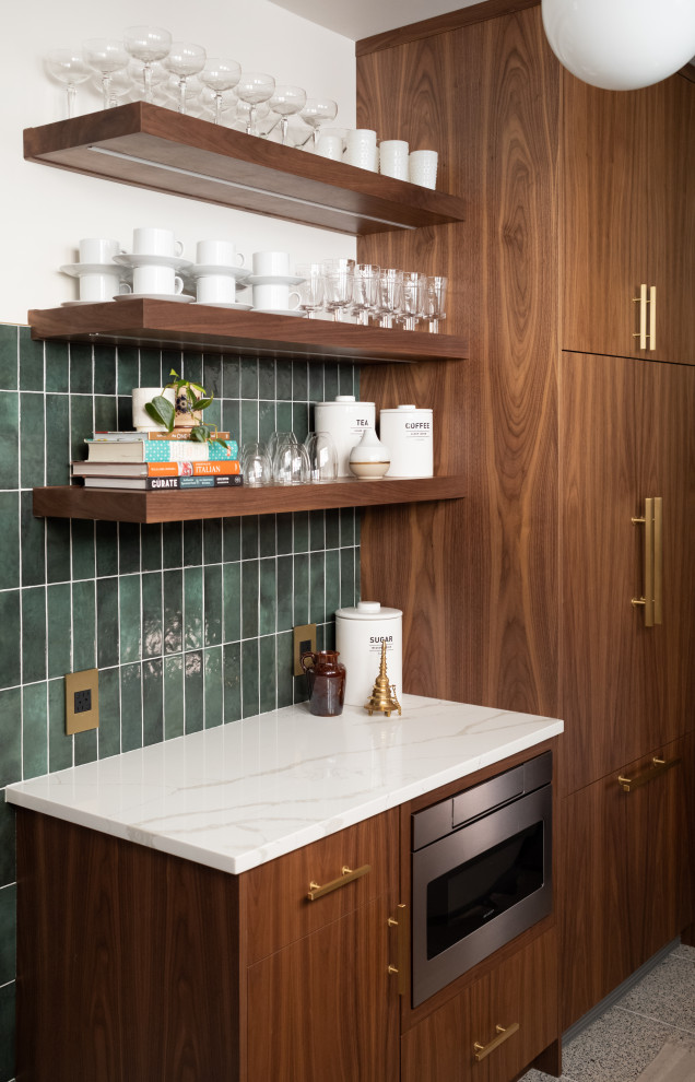 Inspiration for a mid-sized 1950s l-shaped kitchen pantry remodel in Chicago with flat-panel cabinets, medium tone wood cabinets, green backsplash, paneled appliances, no island and white countertops