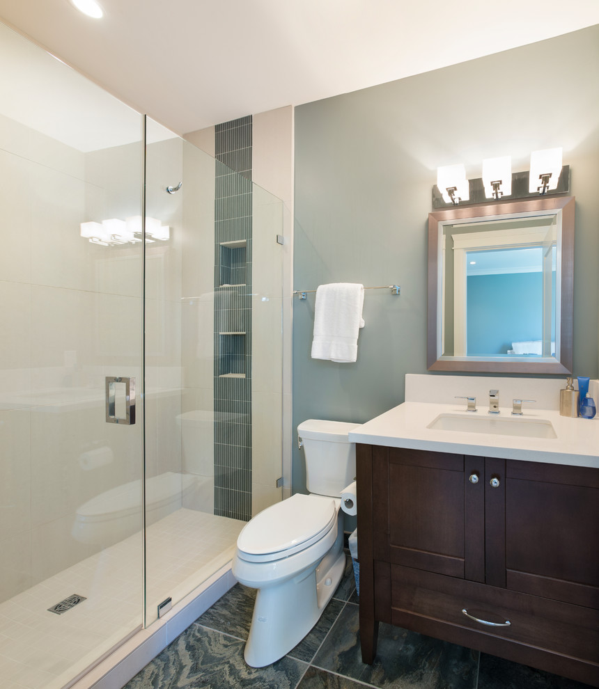 Inspiration for a mid-sized transitional 3/4 bathroom in Vancouver with an undermount sink, shaker cabinets, dark wood cabinets, engineered quartz benchtops, a corner shower, a two-piece toilet, gray tile, porcelain tile, blue walls and porcelain floors.