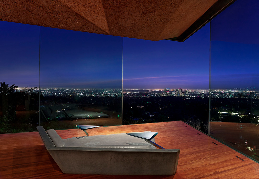 Mid-sized modern master bedroom in Los Angeles with dark hardwood floors.