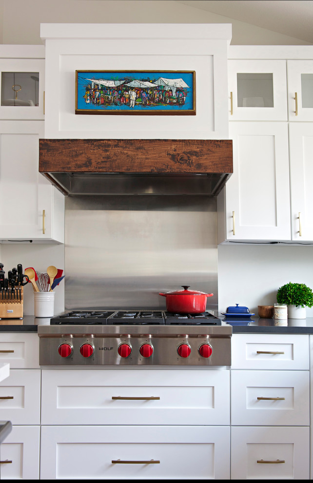 Large transitional l-shaped medium tone wood floor open concept kitchen photo in Indianapolis with an undermount sink, shaker cabinets, white cabinets, quartz countertops, gray backsplash, stainless steel appliances and an island