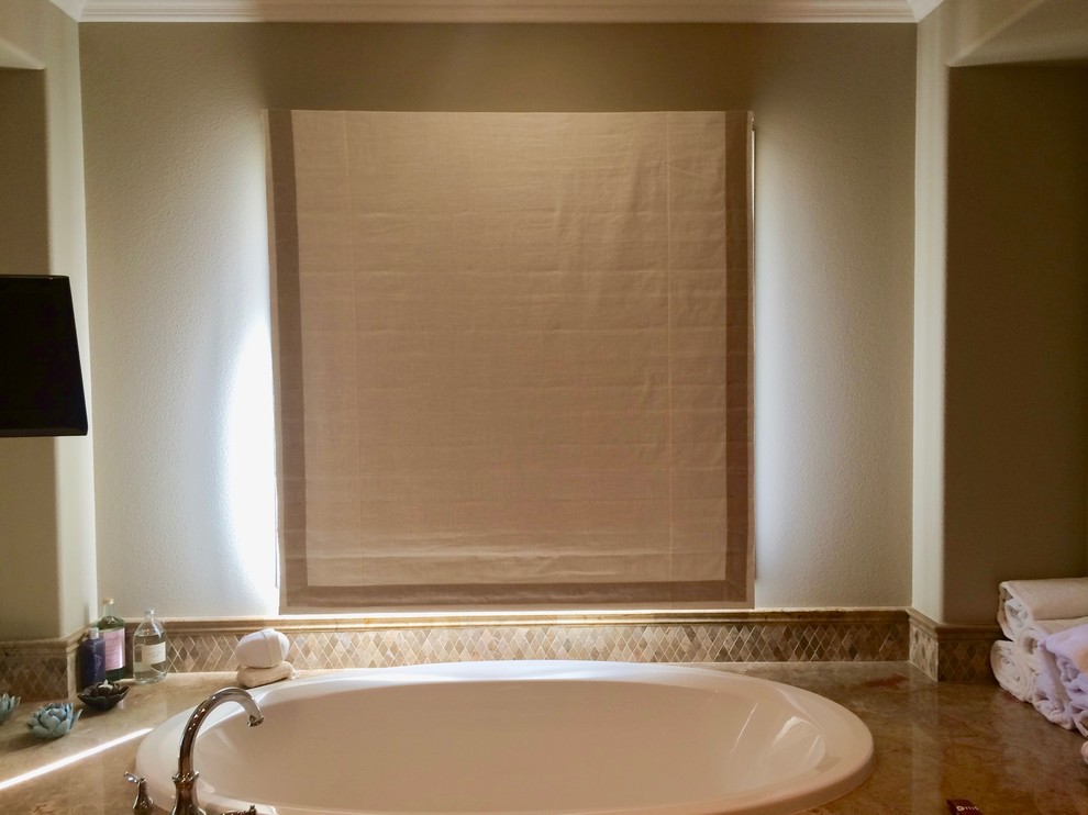 Mid-sized transitional drop-in bathtub photo in Orange County with beige walls