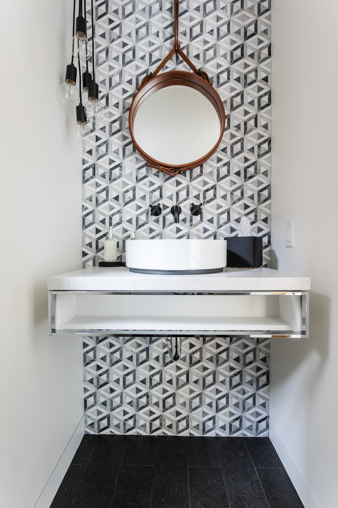 Inspiration for a modern powder room in San Francisco with open cabinets, black and white tile, gray tile, white walls, a vessel sink, black floor and white benchtops.