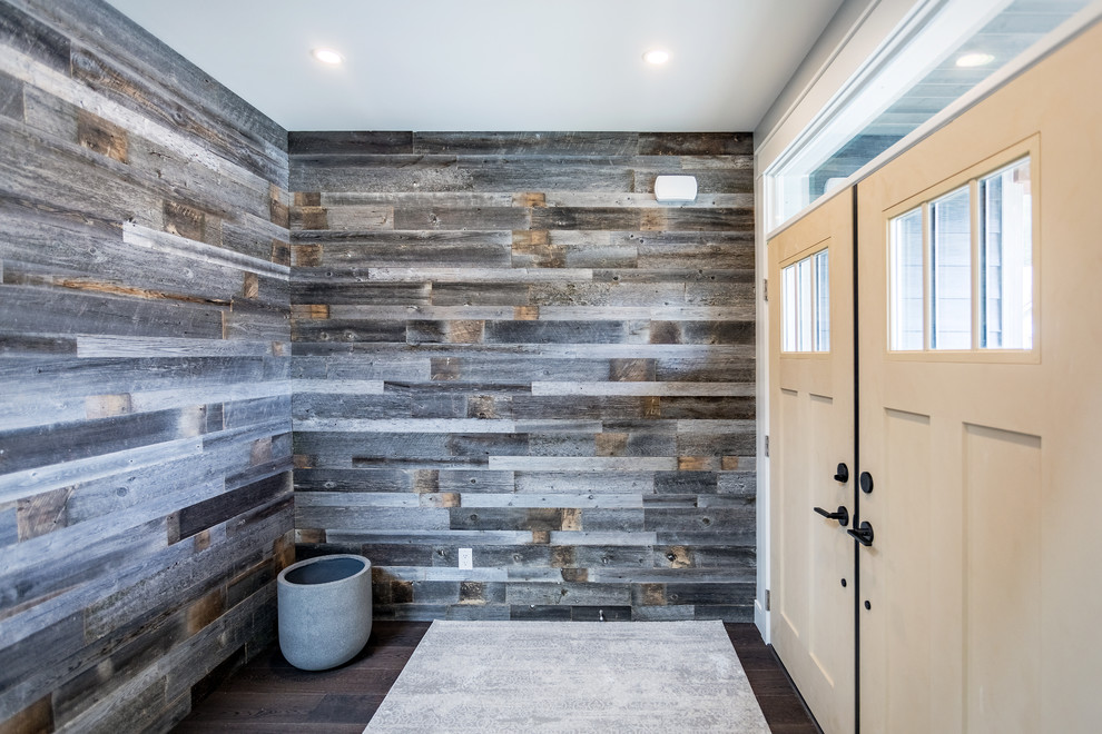 Inspiration for a mid-sized traditional foyer in Vancouver with multi-coloured walls, medium hardwood floors, a double front door and wood walls.