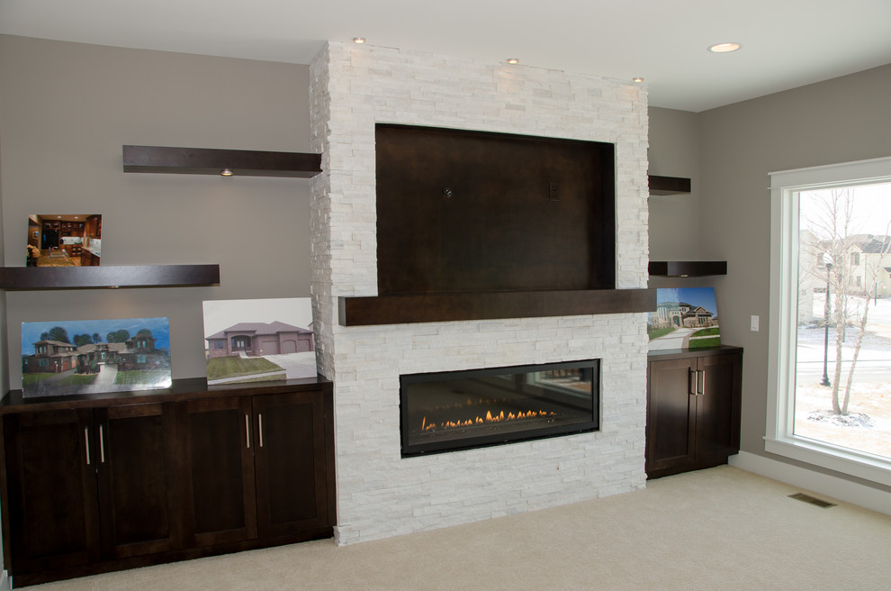 Design ideas for a transitional open concept family room in Omaha with grey walls, carpet, a ribbon fireplace, a stone fireplace surround and a wall-mounted tv.