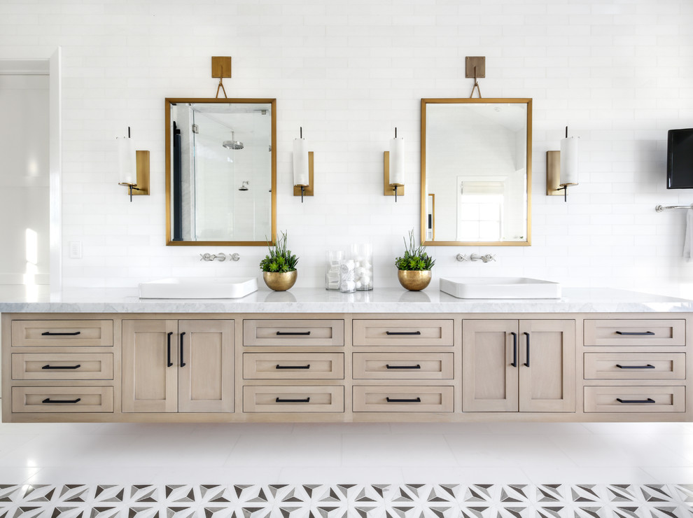 Photo of a large modern master bathroom in Orange County with shaker cabinets, light wood cabinets, white tile, subway tile, white walls, a vessel sink, marble benchtops and white floor.