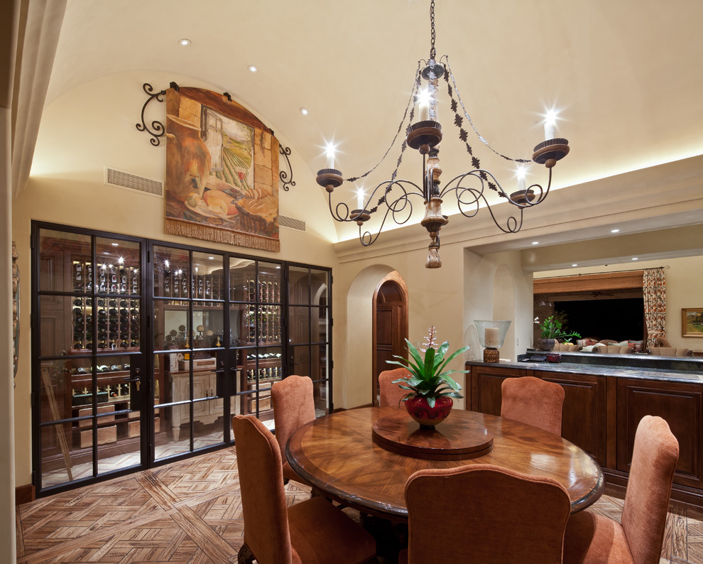 Inspiration for a mediterranean dining room in Orange County with beige walls and dark hardwood floors.