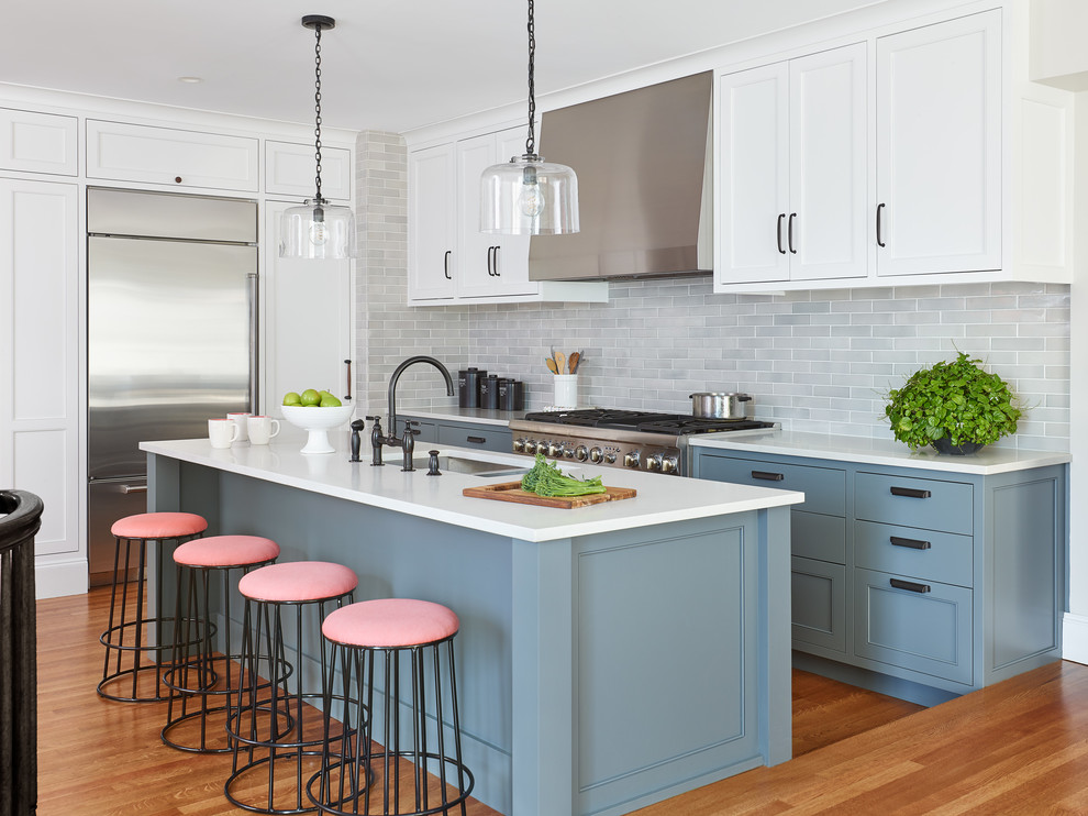 Inspiration for a transitional kitchen in Manchester with an undermount sink, blue cabinets, grey splashback, subway tile splashback, stainless steel appliances, medium hardwood floors, with island, orange floor and white benchtop.