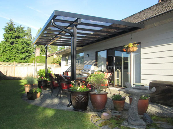 This is an example of a mid-sized backyard patio in Vancouver with concrete slab and an awning.
