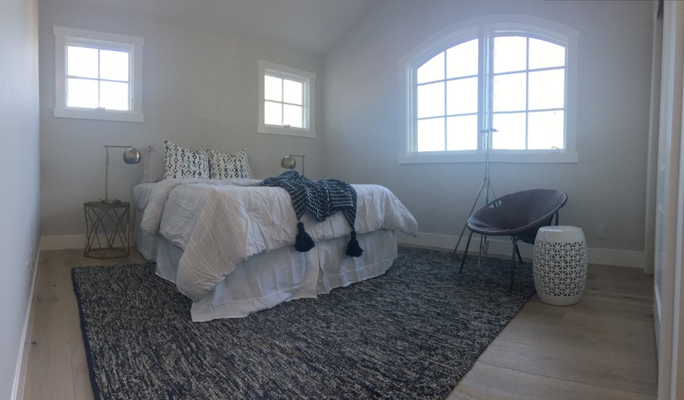 Inspiration for a mid-sized transitional guest light wood floor and beige floor bedroom remodel with gray walls