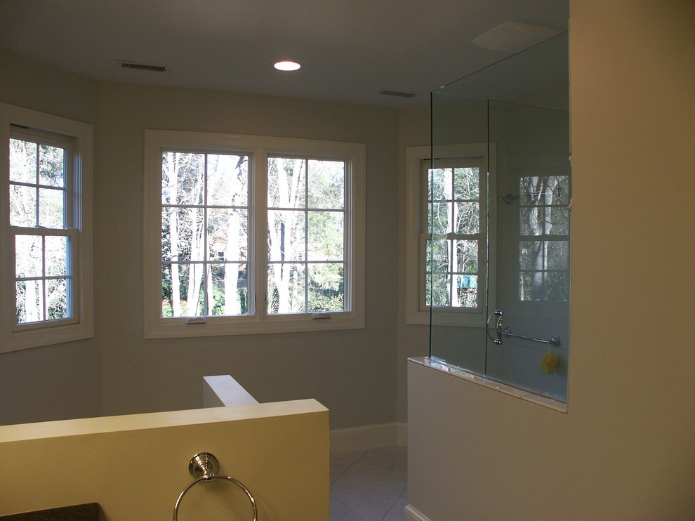 Large transitional master bathroom in Charlotte with raised-panel cabinets, white cabinets, a corner shower, a two-piece toilet, white tile, ceramic tile, white walls, ceramic floors, an undermount sink and engineered quartz benchtops.