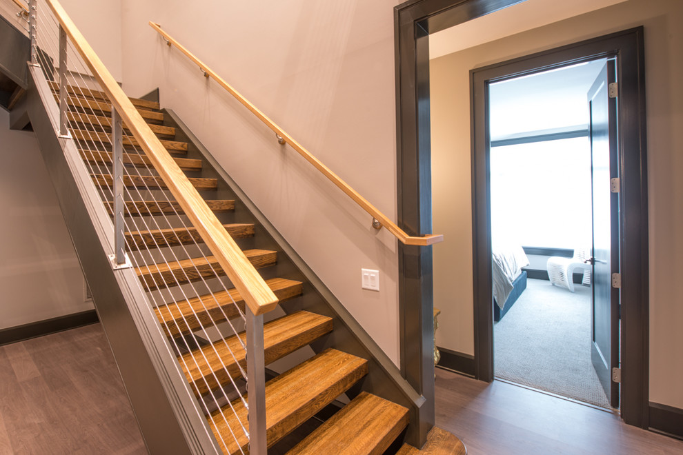 Inspiration for a large transitional wooden u-shaped open staircase remodel