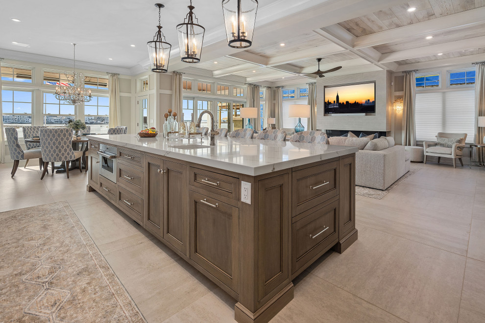 Inspiration for a large coastal porcelain tile and beige floor open concept kitchen remodel in New York with a farmhouse sink, shaker cabinets, medium tone wood cabinets, quartzite countertops, beige backsplash, mosaic tile backsplash, stainless steel appliances, an island and white countertops