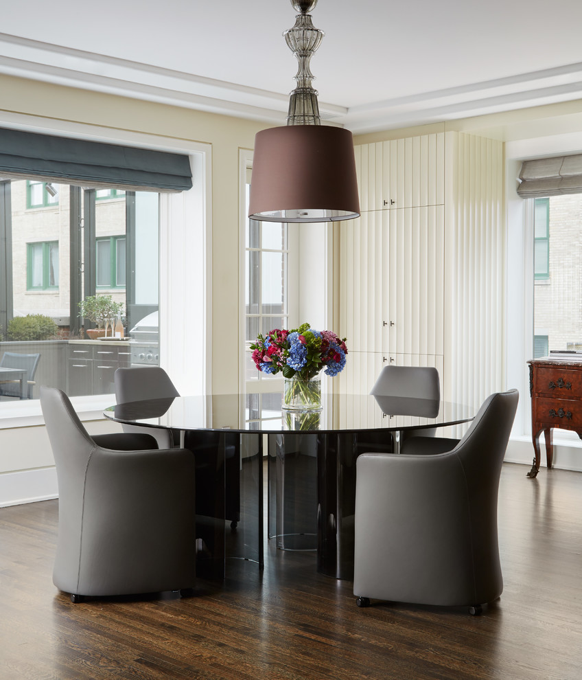 This is an example of an expansive contemporary dining room in Chicago with beige walls and dark hardwood floors.