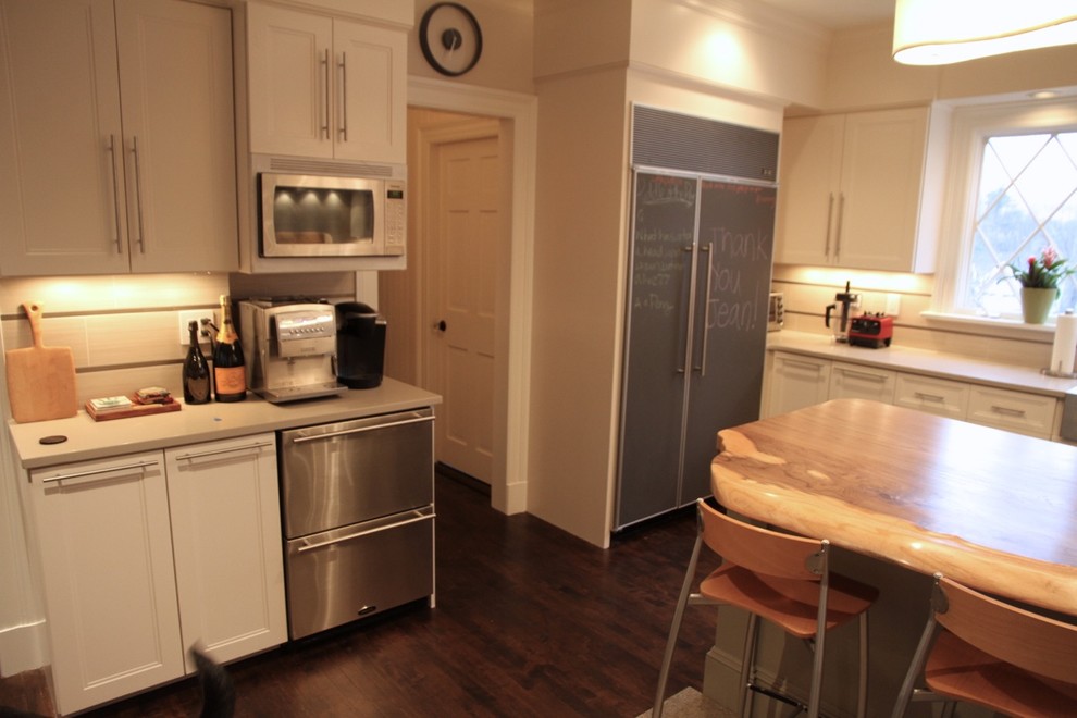 Large transitional u-shaped dark wood floor kitchen pantry photo in Boston with recessed-panel cabinets, light wood cabinets, quartz countertops, beige backsplash, porcelain backsplash, stainless steel appliances and an island