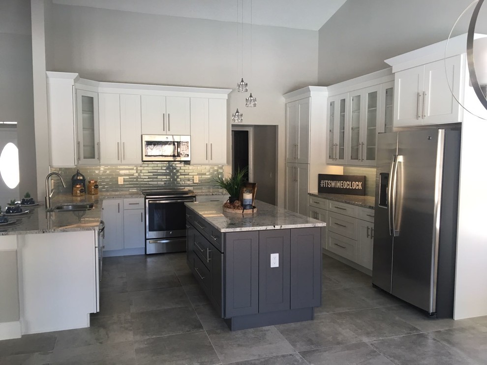 Design ideas for a large contemporary u-shaped eat-in kitchen in Orlando with a double-bowl sink, shaker cabinets, white cabinets, granite benchtops, blue splashback, porcelain splashback, stainless steel appliances, concrete floors, with island and grey floor.