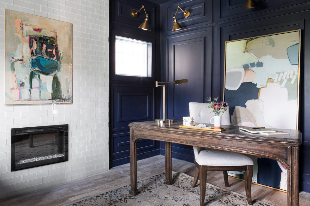 Inspiration for a freestanding desk medium tone wood floor, brown floor and wainscoting study room remodel in Kansas City with blue walls, a standard fireplace and a tile fireplace