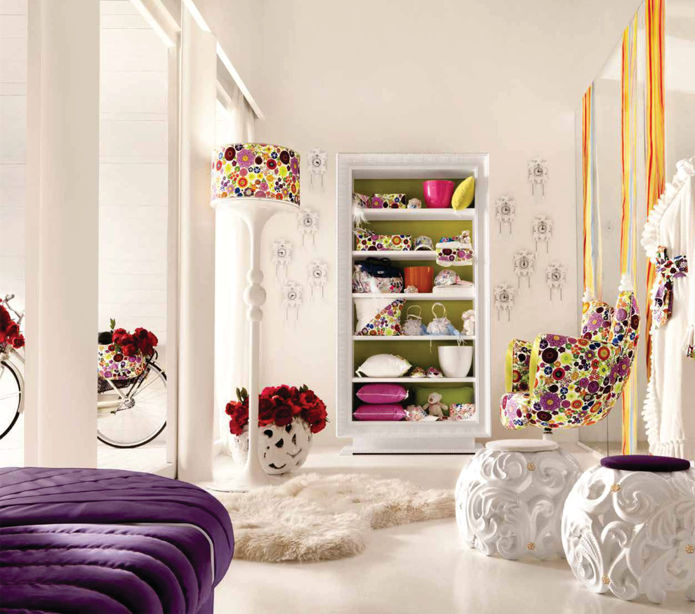 This is an example of a large modern kids' room for girls in London with white walls and carpet.