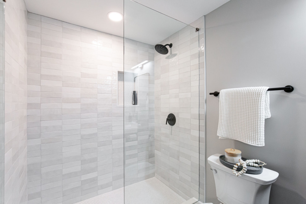 Small trendy kids' white tile and subway tile porcelain tile, white floor and single-sink alcove shower photo in Atlanta with shaker cabinets, dark wood cabinets, marble countertops, a hinged shower door and a niche