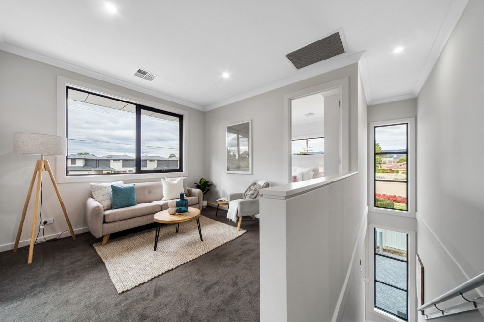 Photo of a modern open concept living room in Adelaide with carpet and grey floor.