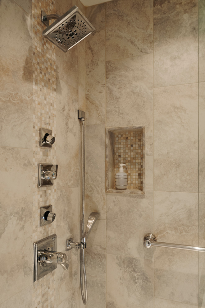 Photo of a large contemporary master bathroom in Other with raised-panel cabinets, white cabinets, a drop-in tub, an open shower, a two-piece toilet, beige tile, porcelain tile, beige walls, porcelain floors, an undermount sink, granite benchtops, beige floor, a hinged shower door, black benchtops, a niche, a double vanity and a freestanding vanity.