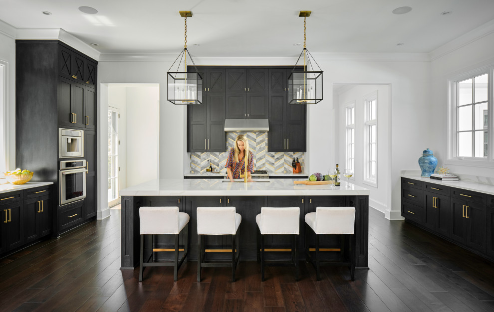 Design ideas for an expansive open plan kitchen with an undermount sink, recessed-panel cabinets, black cabinets, stainless steel appliances, dark hardwood floors, with island and white benchtop.
