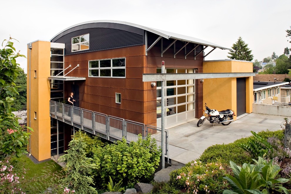 Photo of a mid-sized industrial three-storey multi-coloured exterior in Seattle with mixed siding.