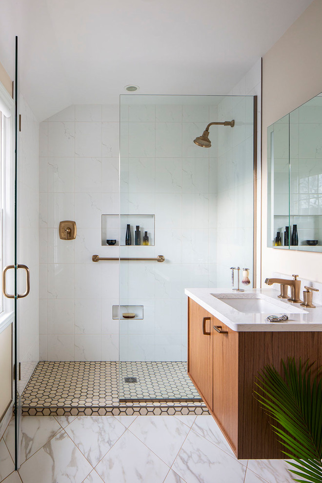 Inspiration for a contemporary bathroom in Milwaukee with flat-panel cabinets, medium wood cabinets, an alcove shower, white tile, beige walls, an undermount sink, white floor, a hinged shower door and white benchtops.