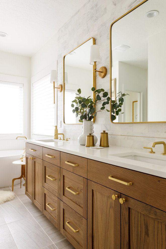 Mid-sized transitional master marble tile ceramic tile, gray floor and double-sink bathroom photo in Boise with shaker cabinets, a one-piece toilet, white walls, an undermount sink, quartz countertops, a hinged shower door, white countertops and a built-in vanity
