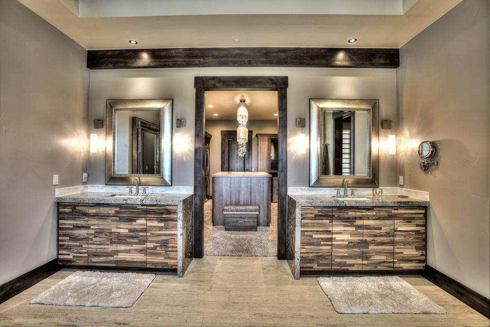 Inspiration for an expansive country master bathroom in Denver with flat-panel cabinets, medium wood cabinets, a drop-in tub, a corner shower, a two-piece toilet, beige tile, multi-coloured tile, ceramic tile, grey walls, slate floors, an undermount sink and granite benchtops.