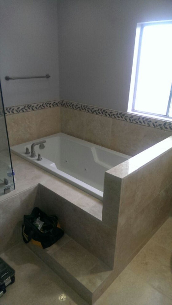 Example of a beige tile and stone tile sauna design with an undermount sink, dark wood cabinets, granite countertops and a two-piece toilet