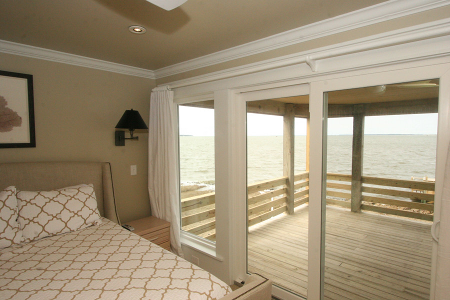 Photo of a mid-sized beach style guest bedroom in Other with beige walls and no fireplace.