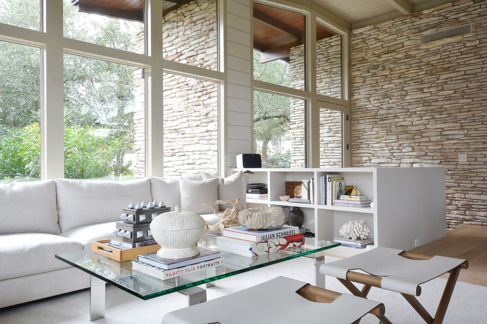 Inspiration for a midcentury formal open concept living room in Austin with beige walls, light hardwood floors and beige floor.