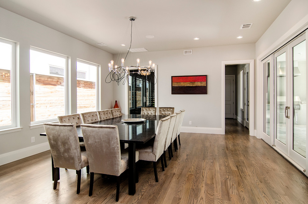Large transitional kitchen/dining combo in Dallas with grey walls, light hardwood floors and no fireplace.