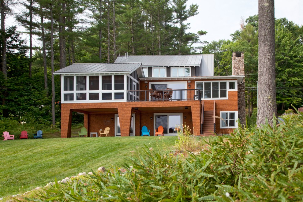 Large beach style house exterior in Portland Maine with three floors, wood cladding and a pitched roof.
