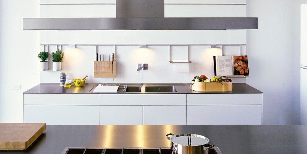 Inspiration for a large modern l-shaped kitchen in Phoenix with with island, an undermount sink, flat-panel cabinets, white cabinets, white splashback, glass sheet splashback and stainless steel appliances.