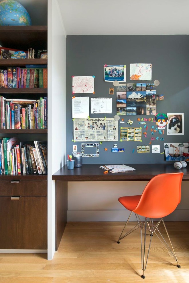 This is an example of a contemporary home office in San Francisco with grey walls, medium hardwood floors and a built-in desk.