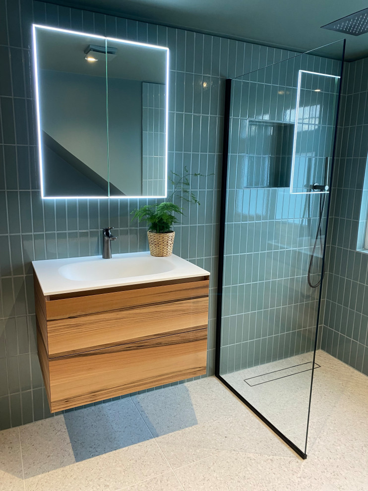 Small contemporary bathroom in London with flat-panel cabinets, a walk-in shower, a one-piece toilet, green tiles, ceramic tiles, green walls, porcelain flooring, a built-in sink, grey floors, an open shower, white worktops, a wall niche, a single sink and a floating vanity unit.