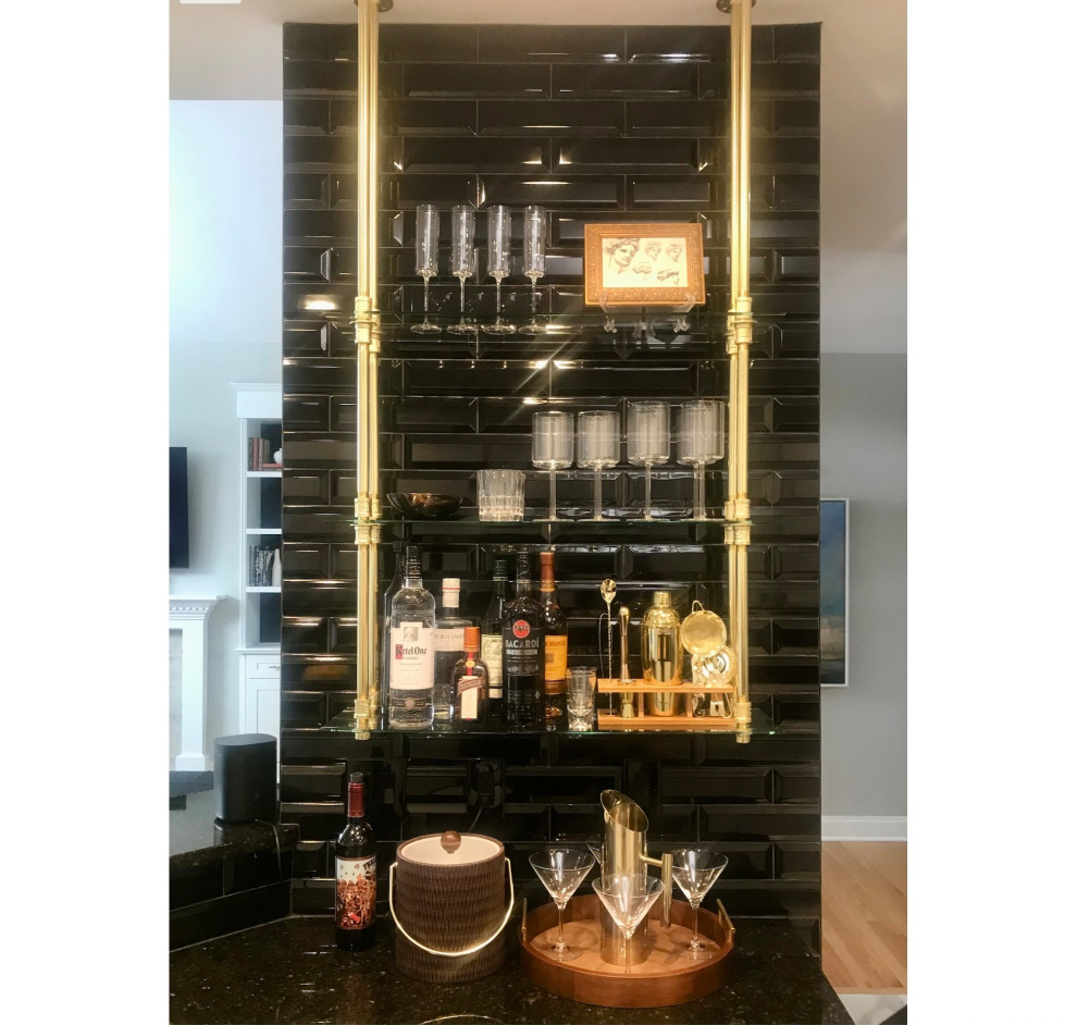 Photo of a mid-sized l-shaped wet bar in Other with an undermount sink, shaker cabinets, white cabinets, granite benchtops, black splashback, ceramic splashback, ceramic floors, black floor and black benchtop.