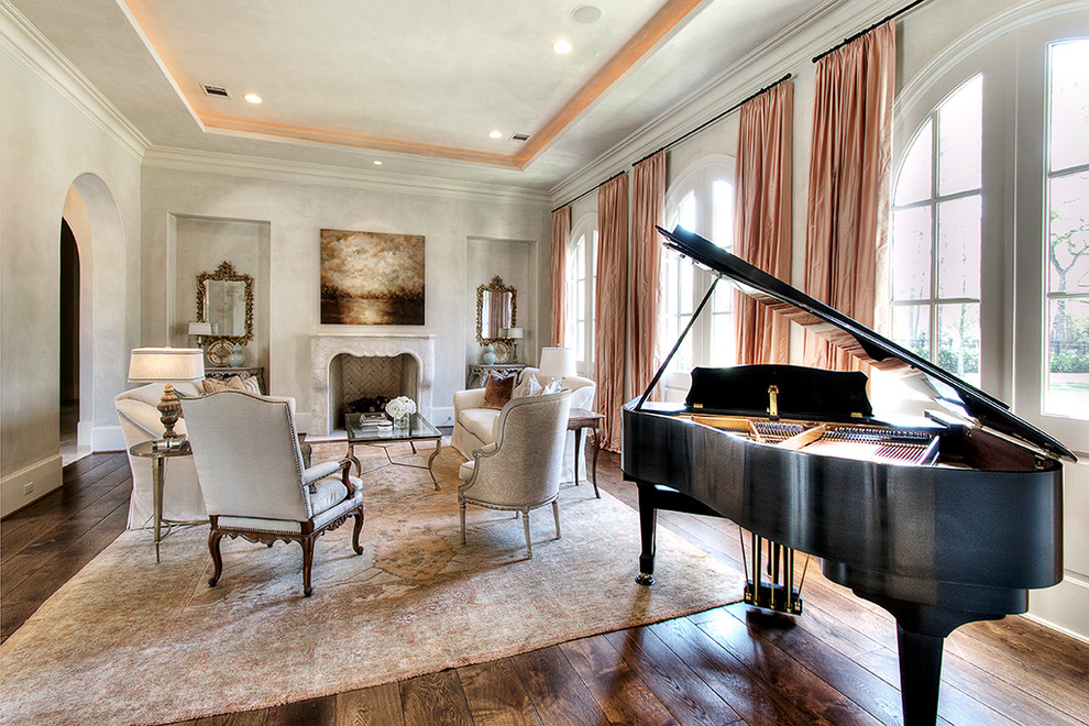 Photo of a traditional living room in Houston with a music area, beige walls, dark hardwood floors, a standard fireplace and a stone fireplace surround.