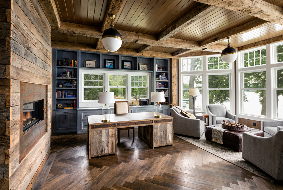 Design ideas for a country study room in Chicago with dark hardwood floors, a ribbon fireplace, a metal fireplace surround and a freestanding desk.