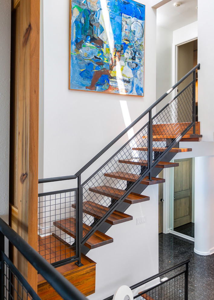 Photo of a contemporary wood straight staircase in Miami with open risers.