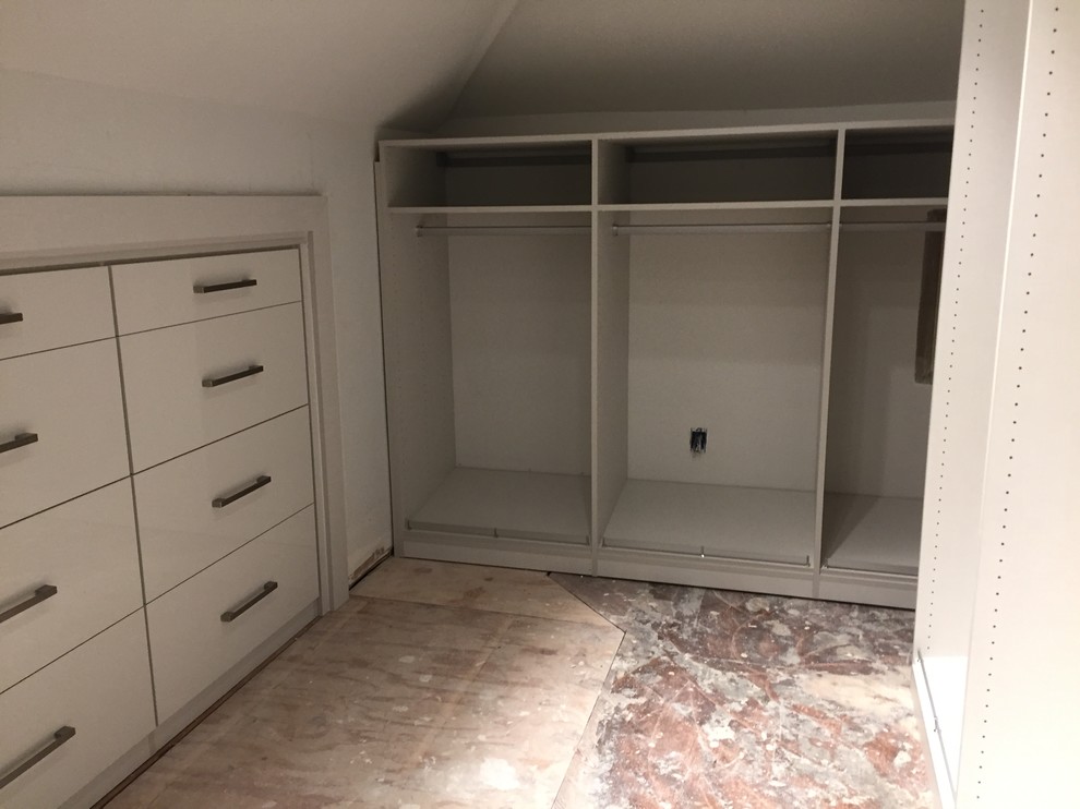 Design ideas for a large contemporary gender-neutral walk-in wardrobe in New Orleans with flat-panel cabinets, white cabinets and ceramic floors.