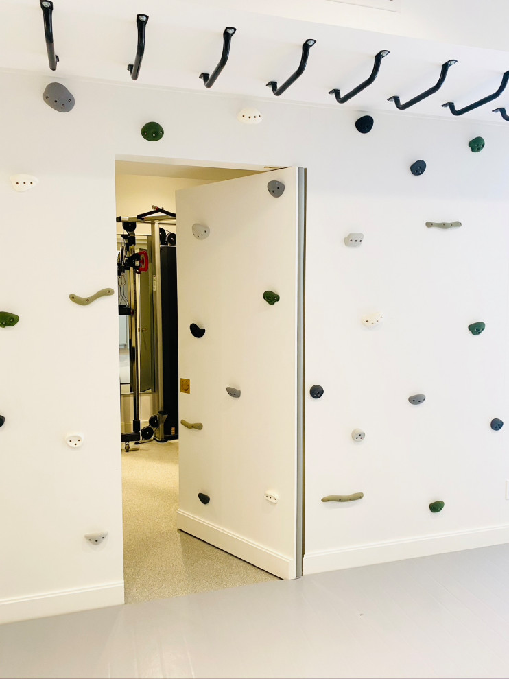 Minimalist perfection! - Mid-sized country gender-neutral light wood floor, gray floor, wood ceiling and wall paneling playroom photo in New York with white walls
