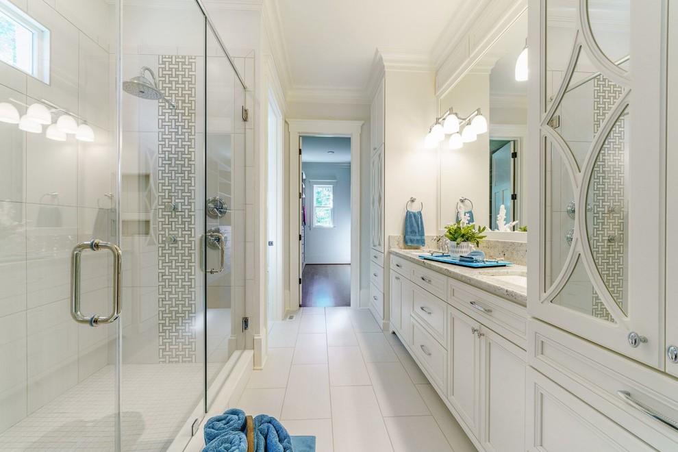 Inspiration for a large master bathroom in Other with louvered cabinets, white cabinets, a corner shower, white walls, porcelain floors, an undermount sink, granite benchtops, white floor, a hinged shower door and multi-coloured benchtops.