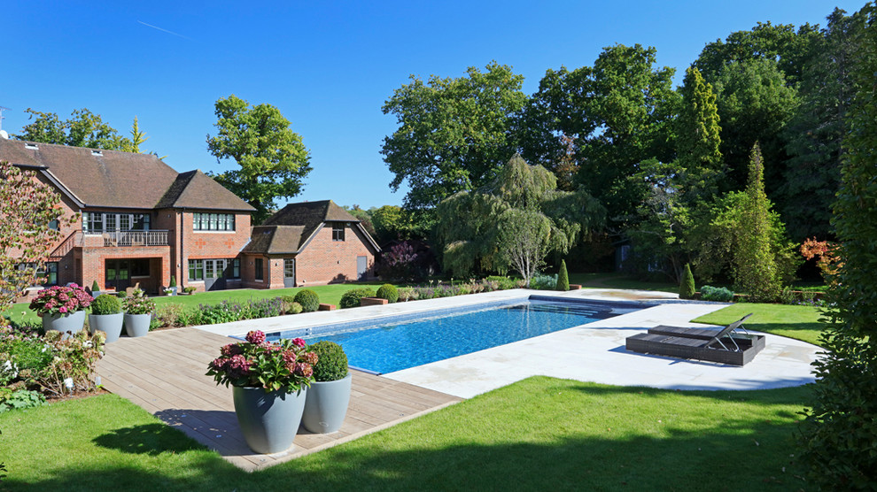 Photo of a mid-sized transitional front yard rectangular lap pool in Other.