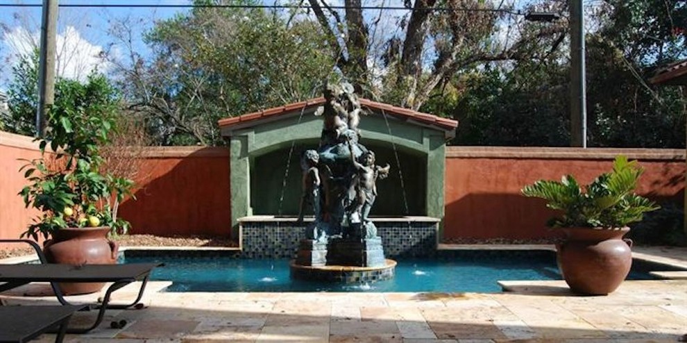 Example of a mid-sized backyard stone and rectangular natural pool fountain design