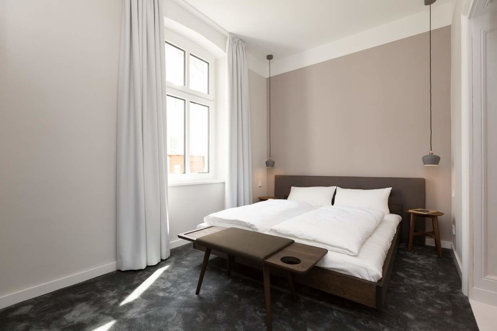 Mid-sized scandinavian master bedroom in Berlin with beige walls, carpet, grey floor and no fireplace.