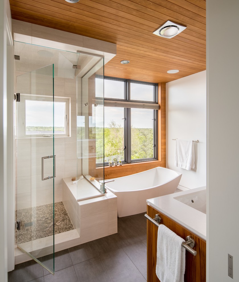 Design ideas for a mid-sized asian master bathroom in Denver with a freestanding tub, an alcove shower, a two-piece toilet, white walls, porcelain floors, an undermount sink, brown floor and a hinged shower door.