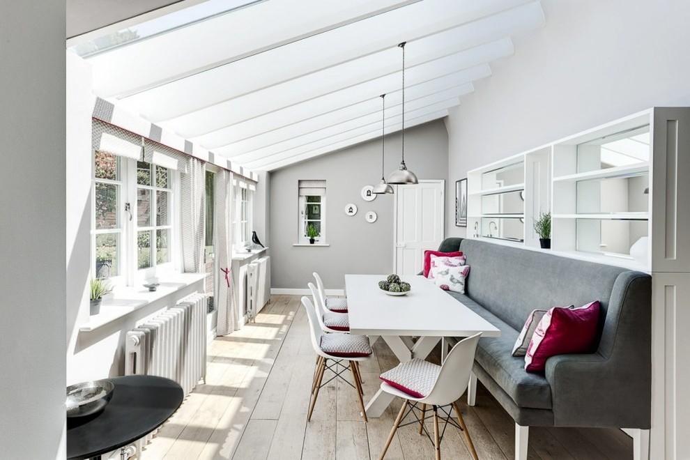 Inspiration for a mid-sized contemporary sunroom in Hampshire with light hardwood floors, beige floor and no fireplace.