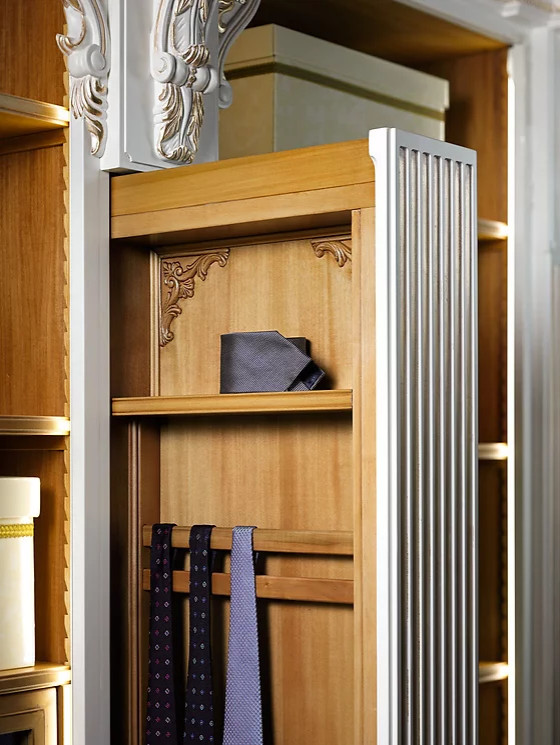 Photo of an expansive traditional gender-neutral walk-in wardrobe in New York with recessed-panel cabinets, medium wood cabinets, light hardwood floors, white floor and wood.
